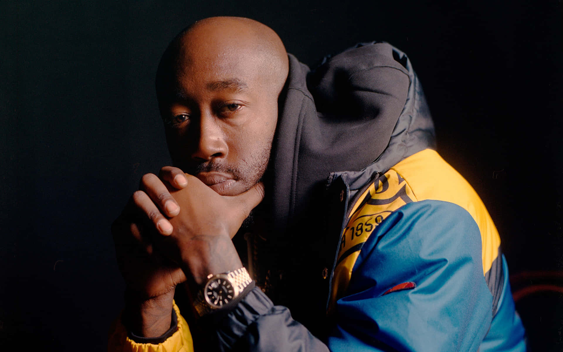 Contemplative_ Man_in_ Hoodie_and_ Gold_ Watch Background
