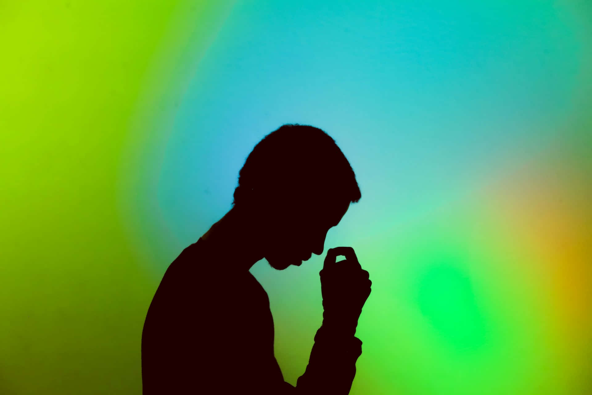 Contemplative Silhouette Against Colorful Backdrop.jpg