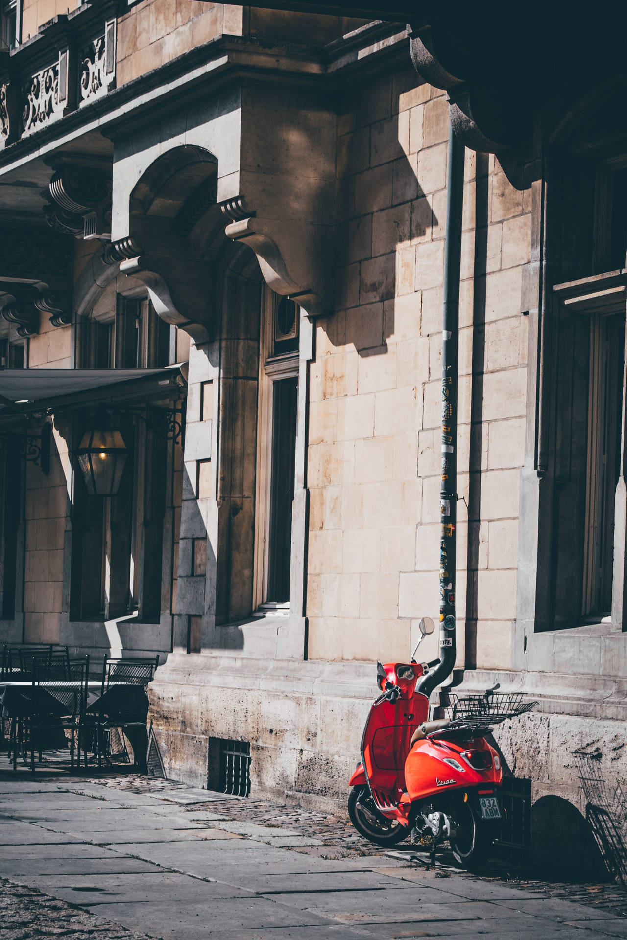 Contemporary Red Vespa Bike Parked Outdoors Background