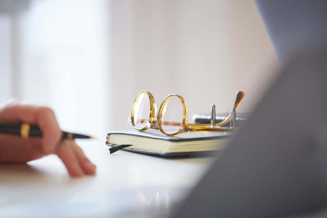 Contract Documents And Golden Eyeglasses Background