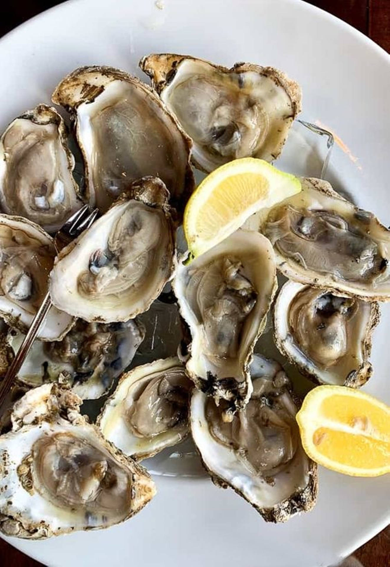 Cooked Oyster On Plate With Lemon Background