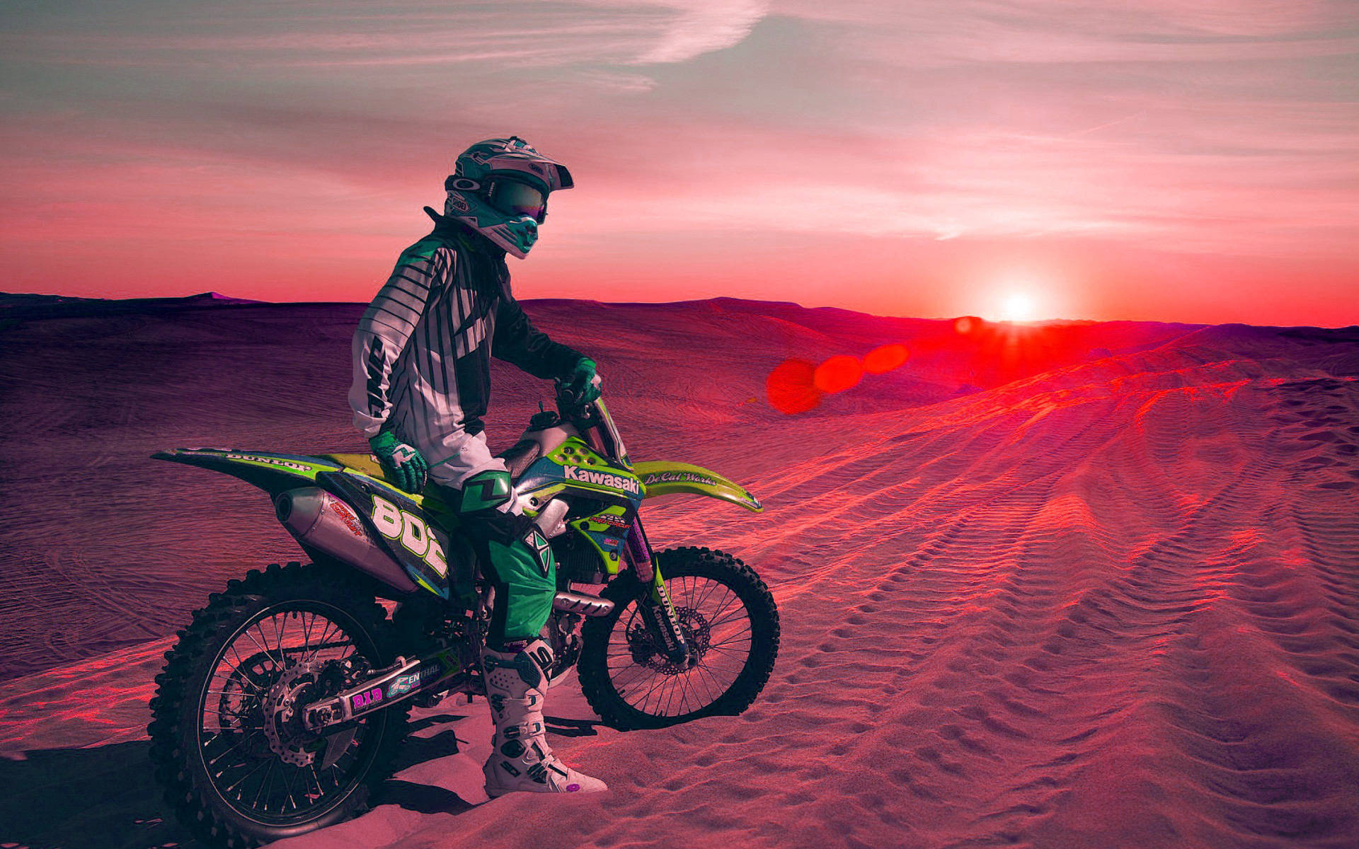 Cool Bike Rider On A Desert At Sunset Background