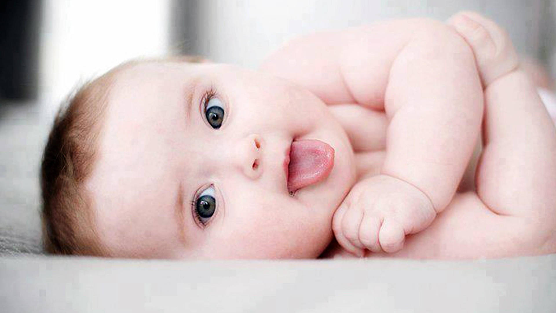 Cool Cute Baby With Tongue Out Background