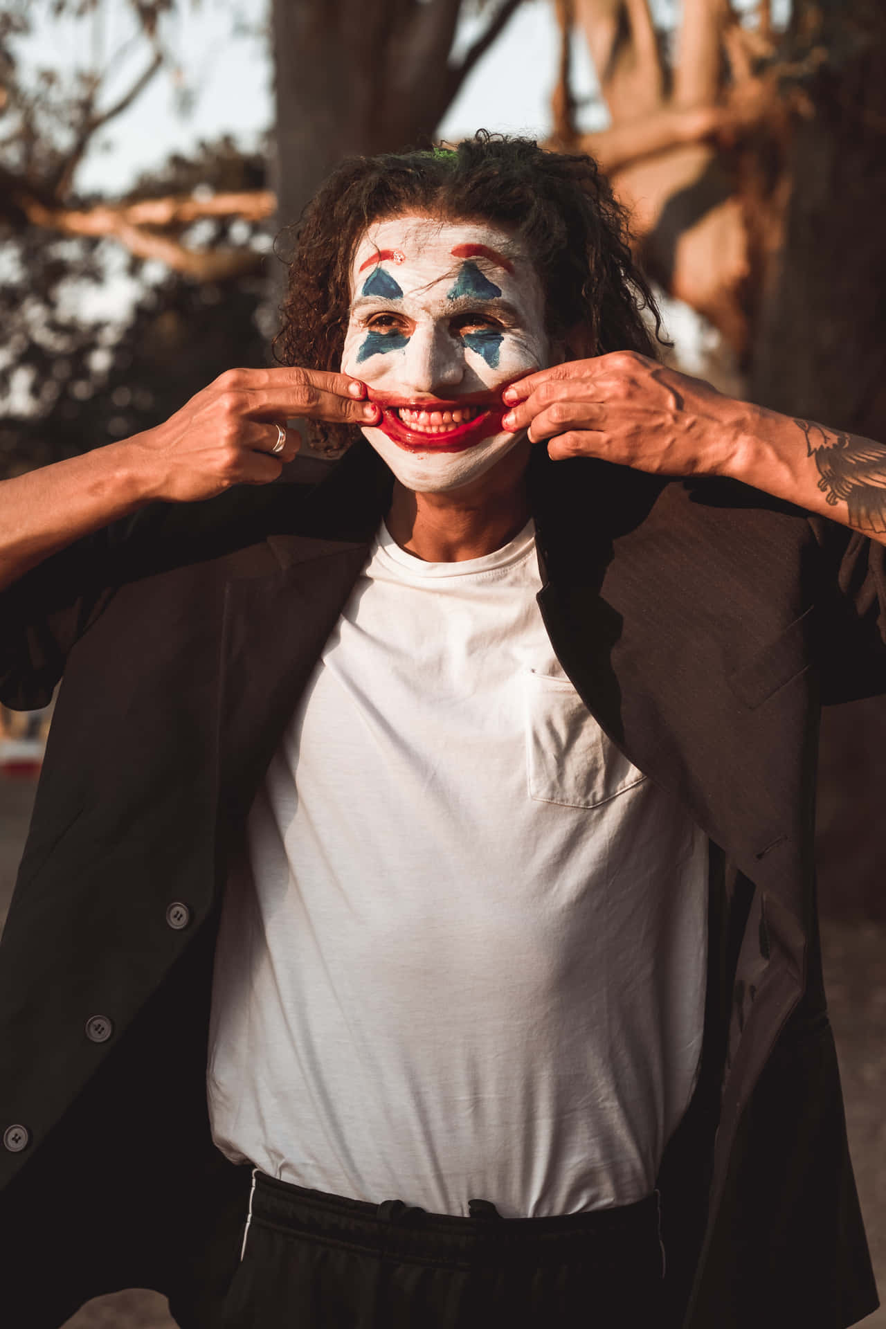 Cool Joker Forcing A Smile Background