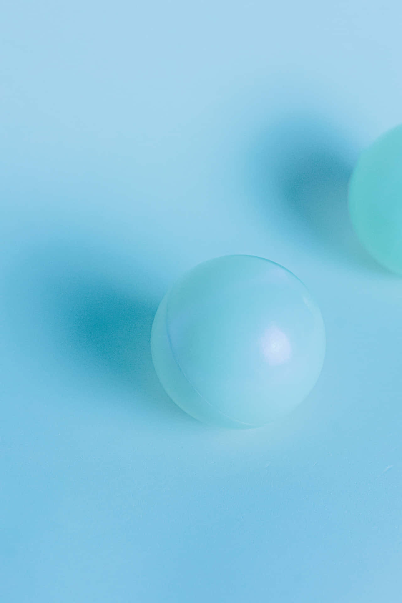 Cool Light Blue Marbles On Surface Background