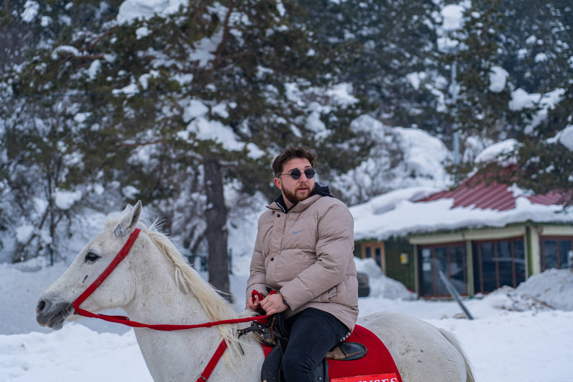 Cool Man Riding A Horse In Winter Background