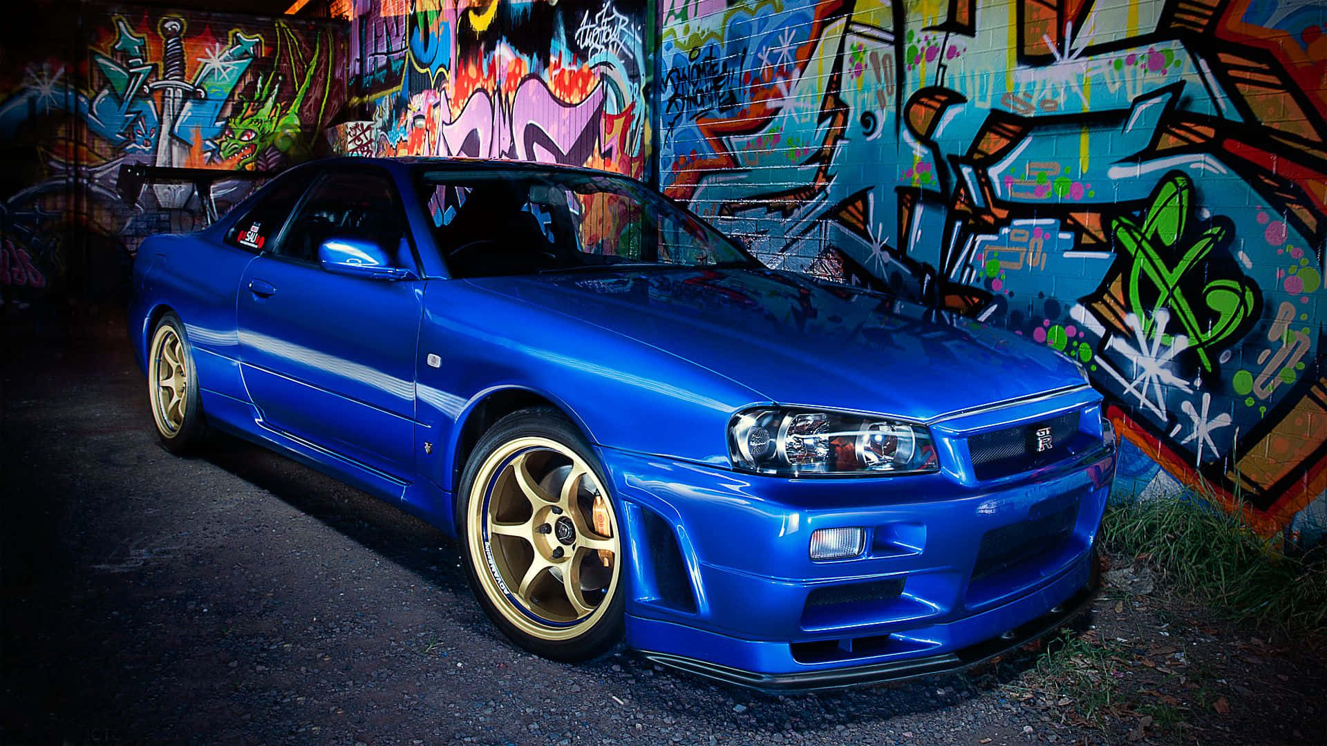 Cool Nissan Skyline Gtr In Blue With Gold Mags Background