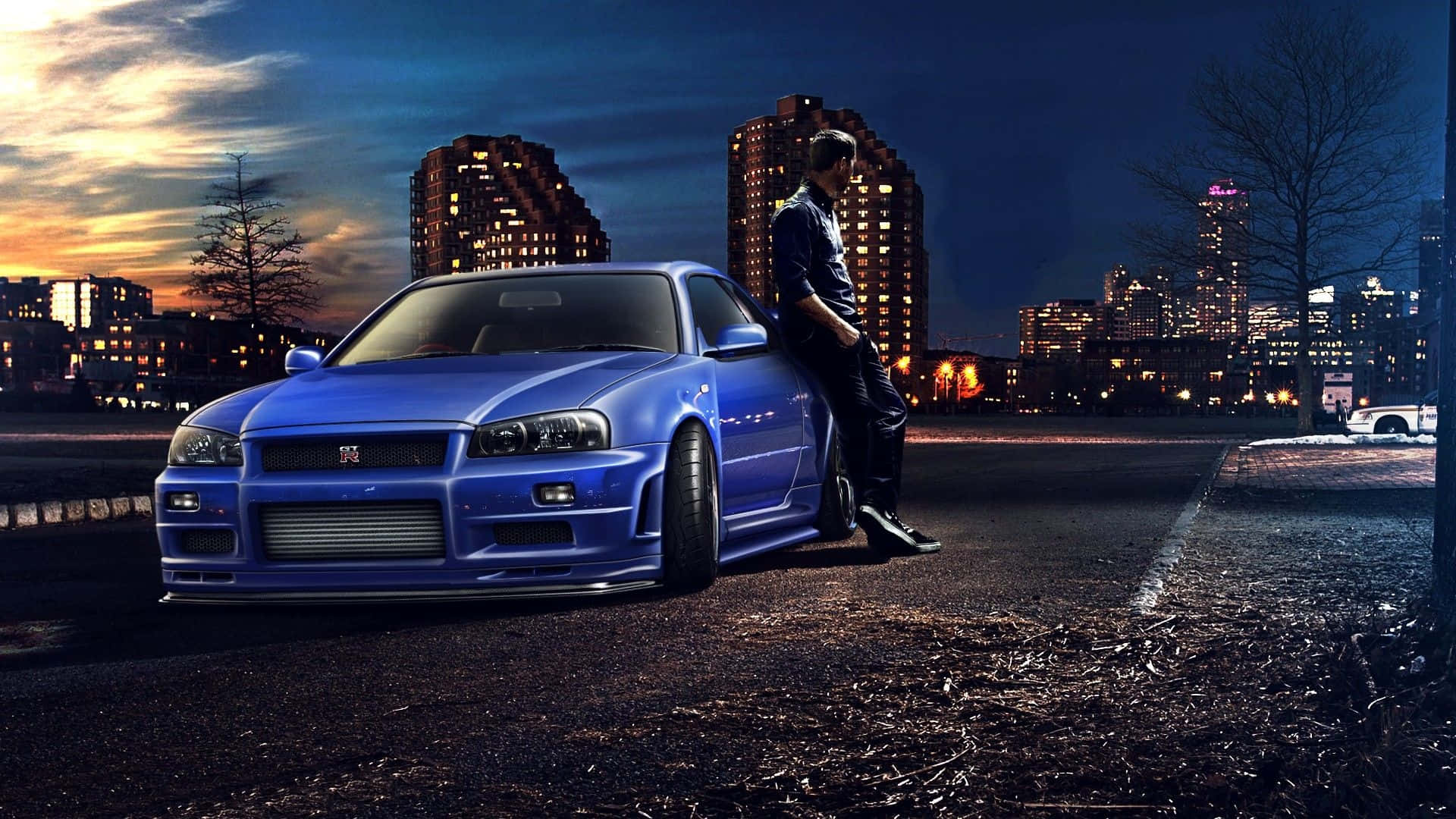 Cool Nissan Skyline With A Man Leaning On Its Side Background