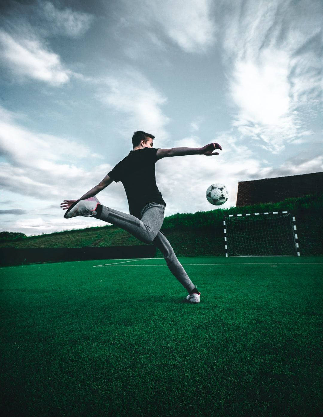 Cool Pfp Football Player Kicking Ball Background