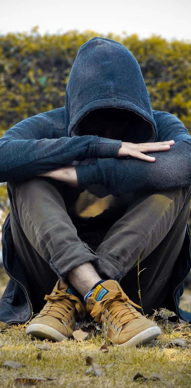 Cool Sad Boy Sitting In A Meadow