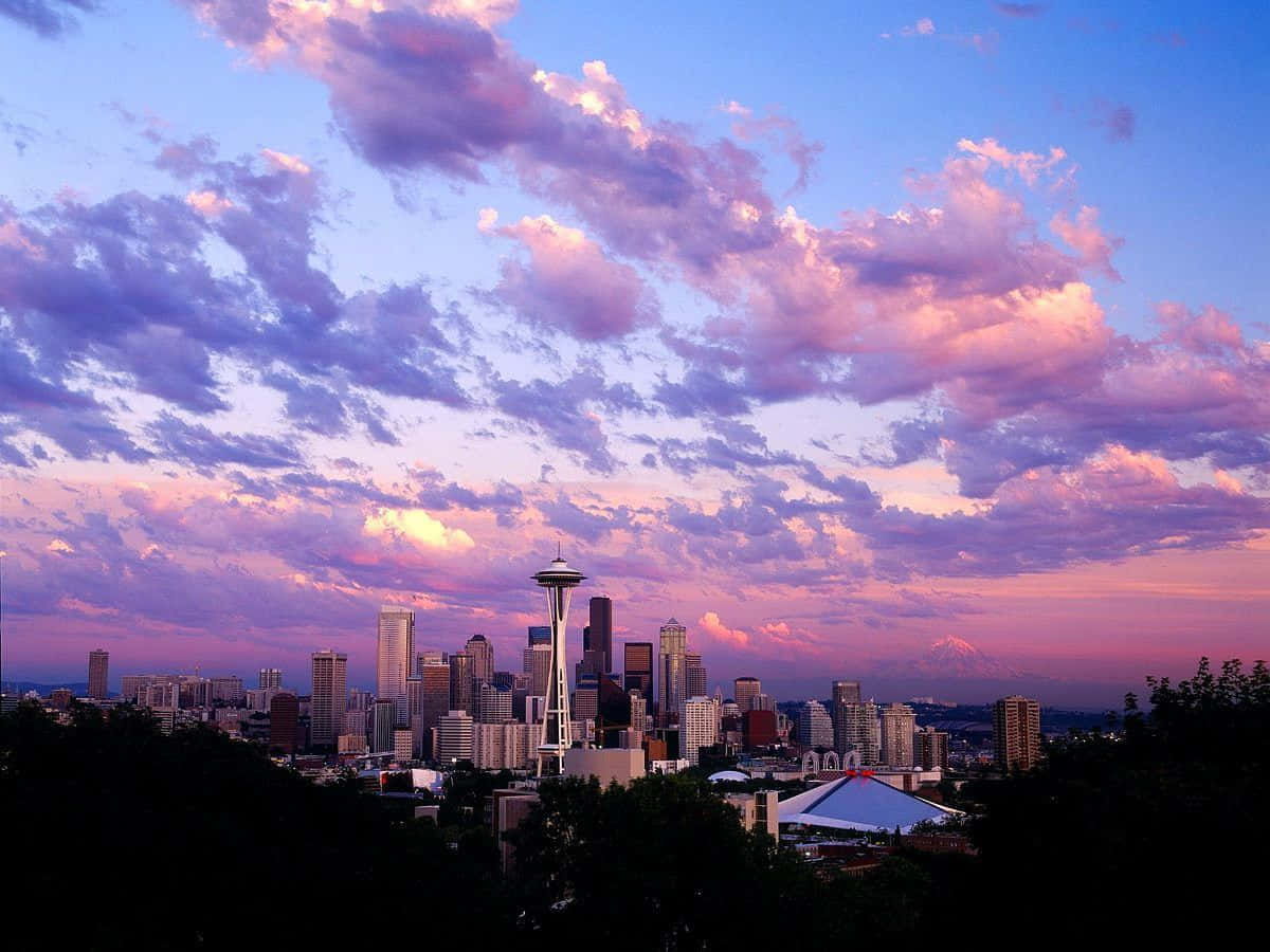 Cool Seattle City Under Purple And Orange Clouds Background