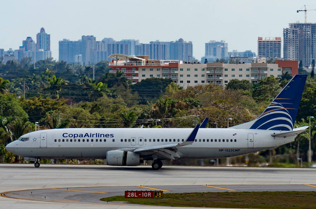 Copa Airlines Plane With Buildings And Trees Background