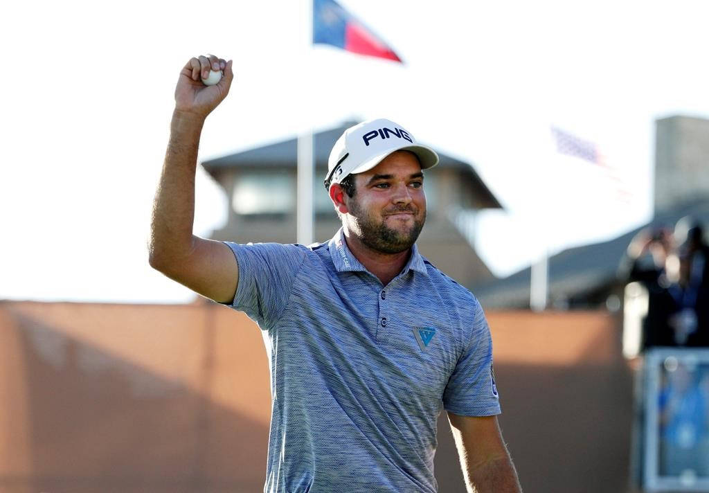 Corey Conners Holding A Golf Ball Background