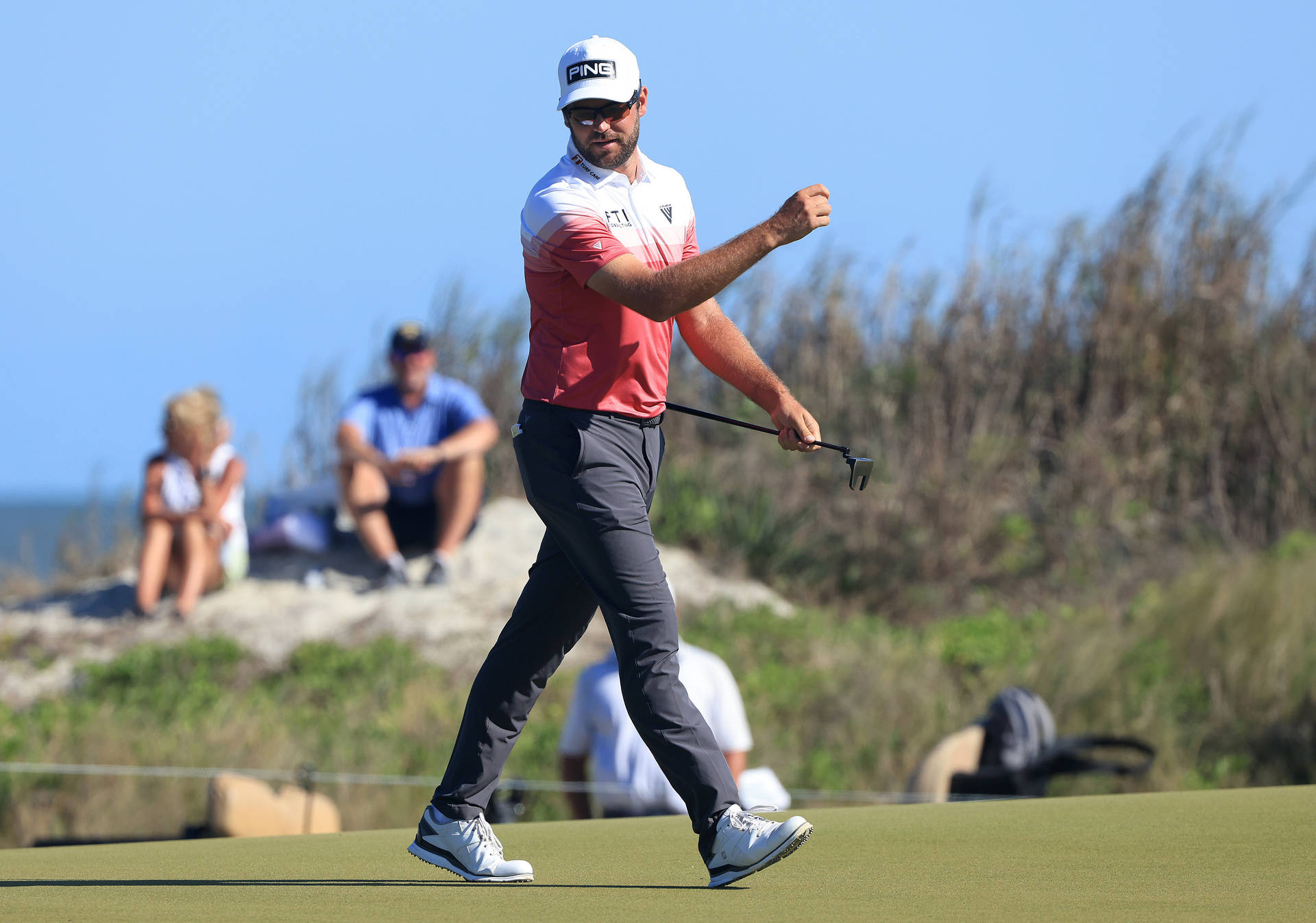 Corey Conners Striding On The Golf Course Background