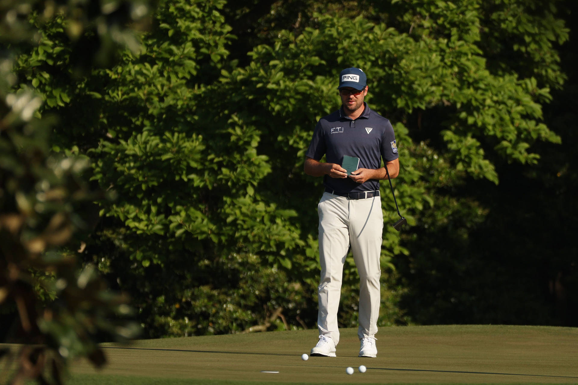 Corey Conners Walking On A Golf Course Background