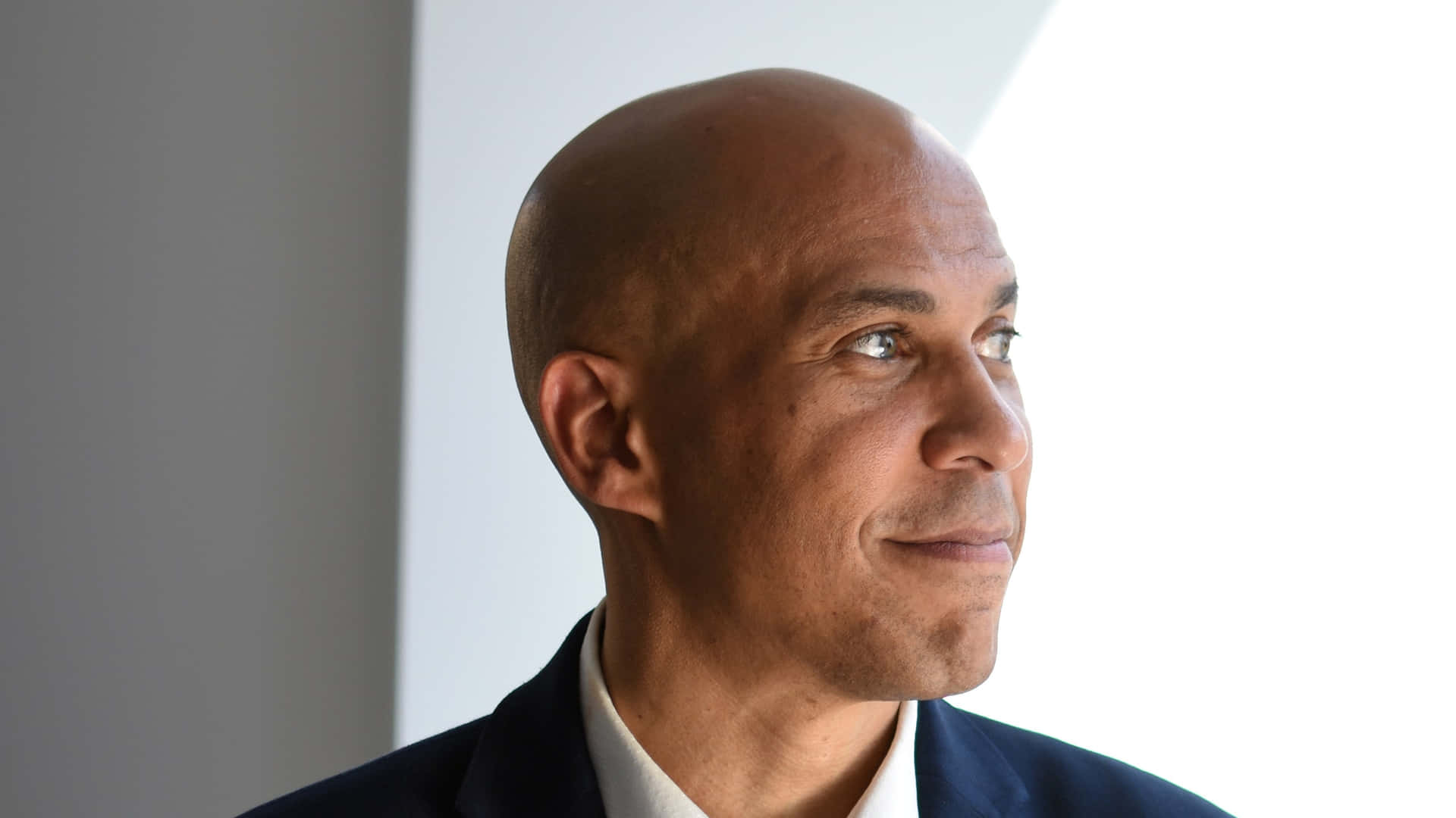 Cory Booker Exuding Charisma With A Captivating Smile Background