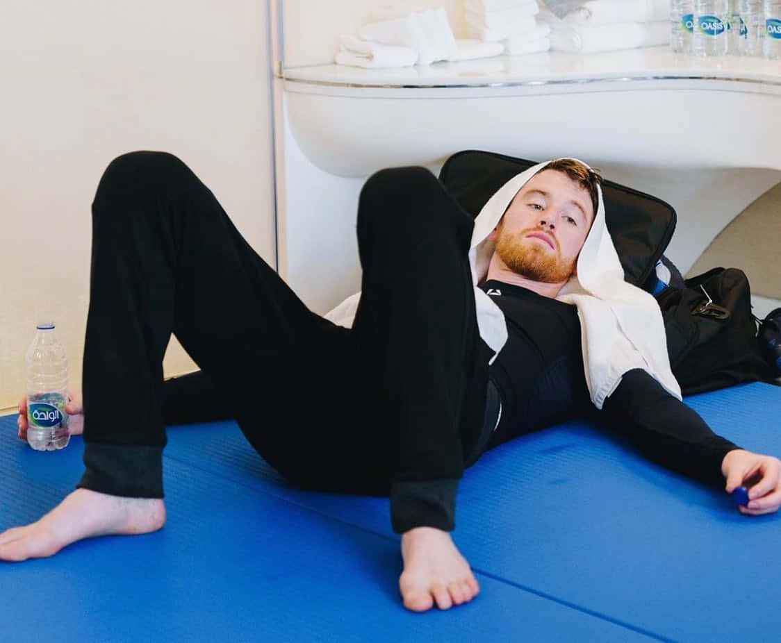 Cory Sandhagen Lying On The Floor Background