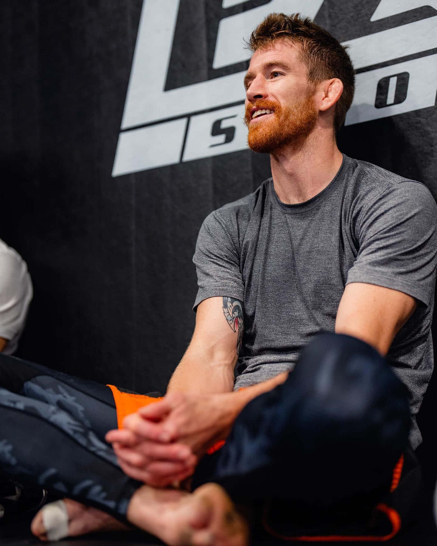 Cory Sandhagen Sitting On The Floor Background