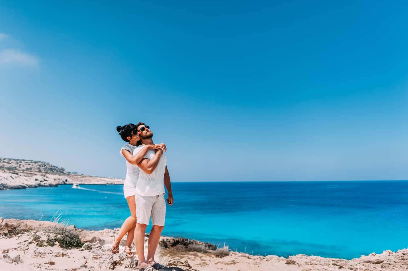 Couple At Beach Blue Skies Background