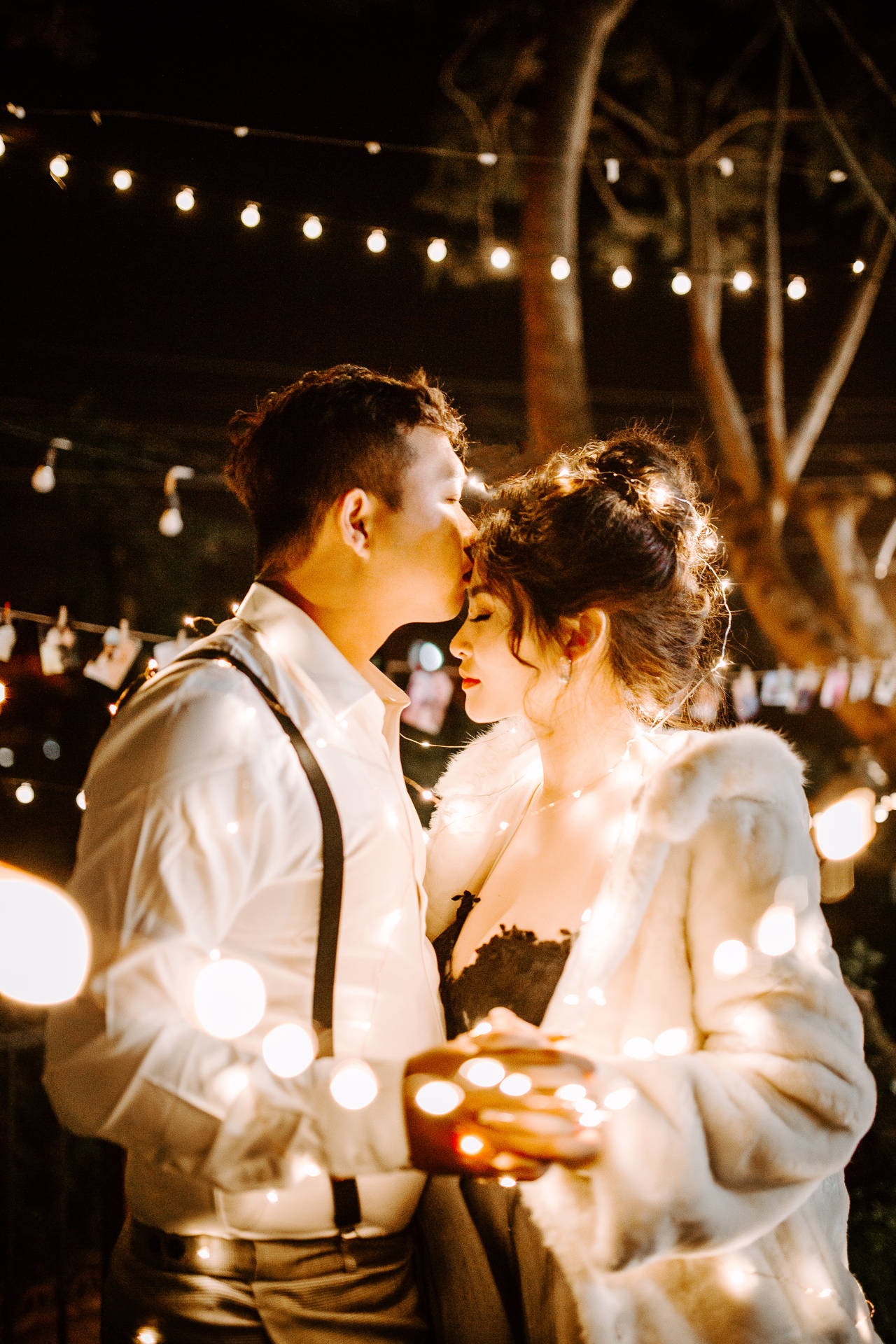 Couple Dancing Under Twinkle Lights Background