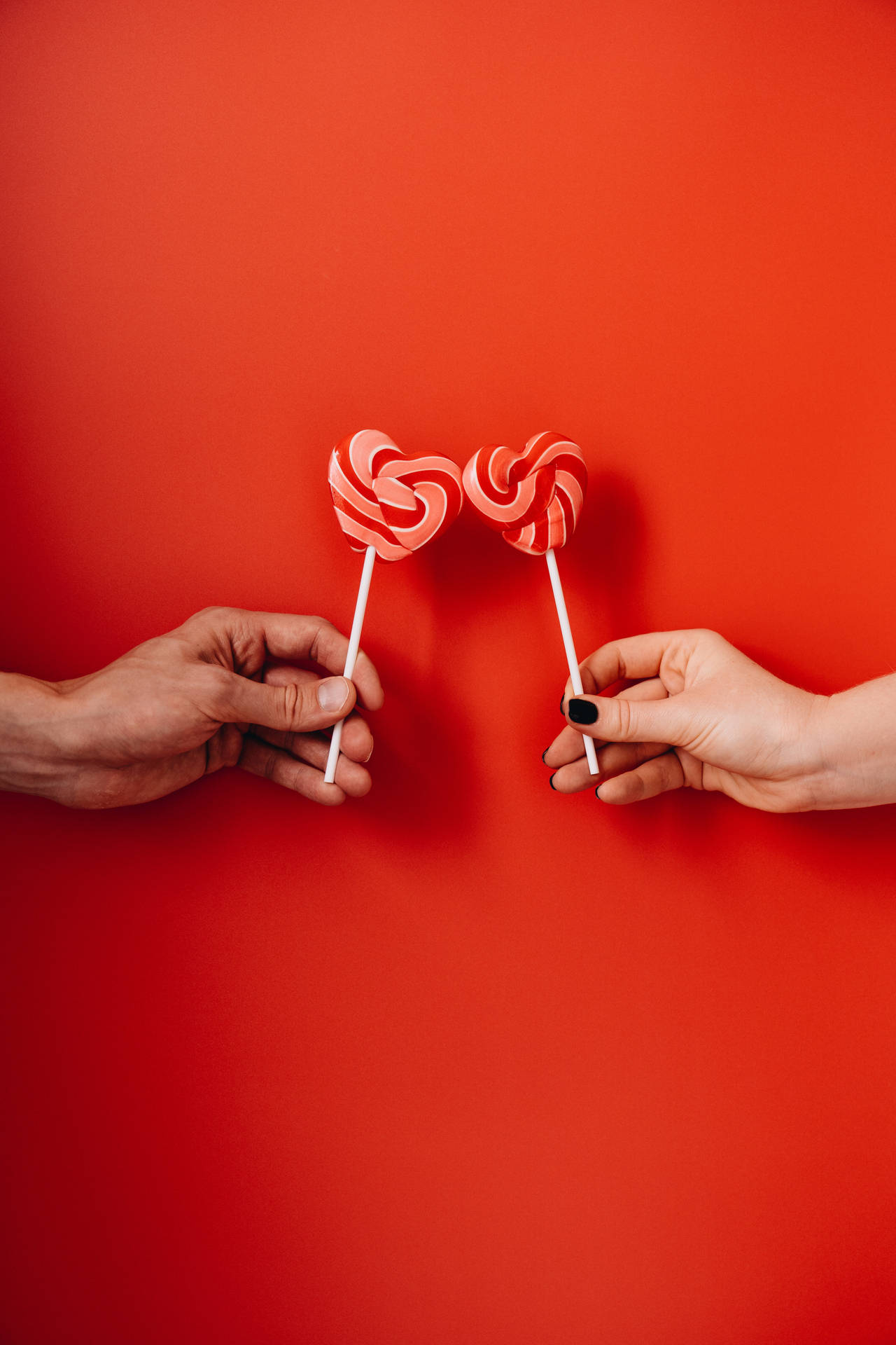 Couple Hands Heart Shaped Lollipops Background