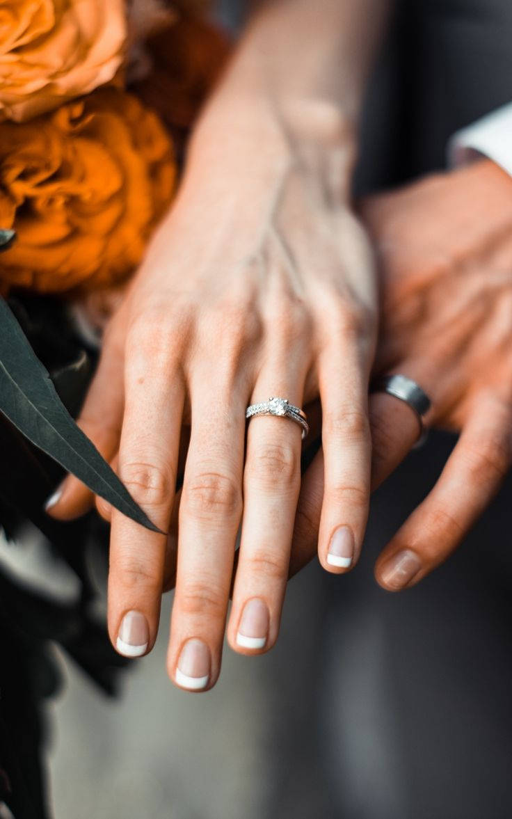 Couple Hands With Wedding Rings Background