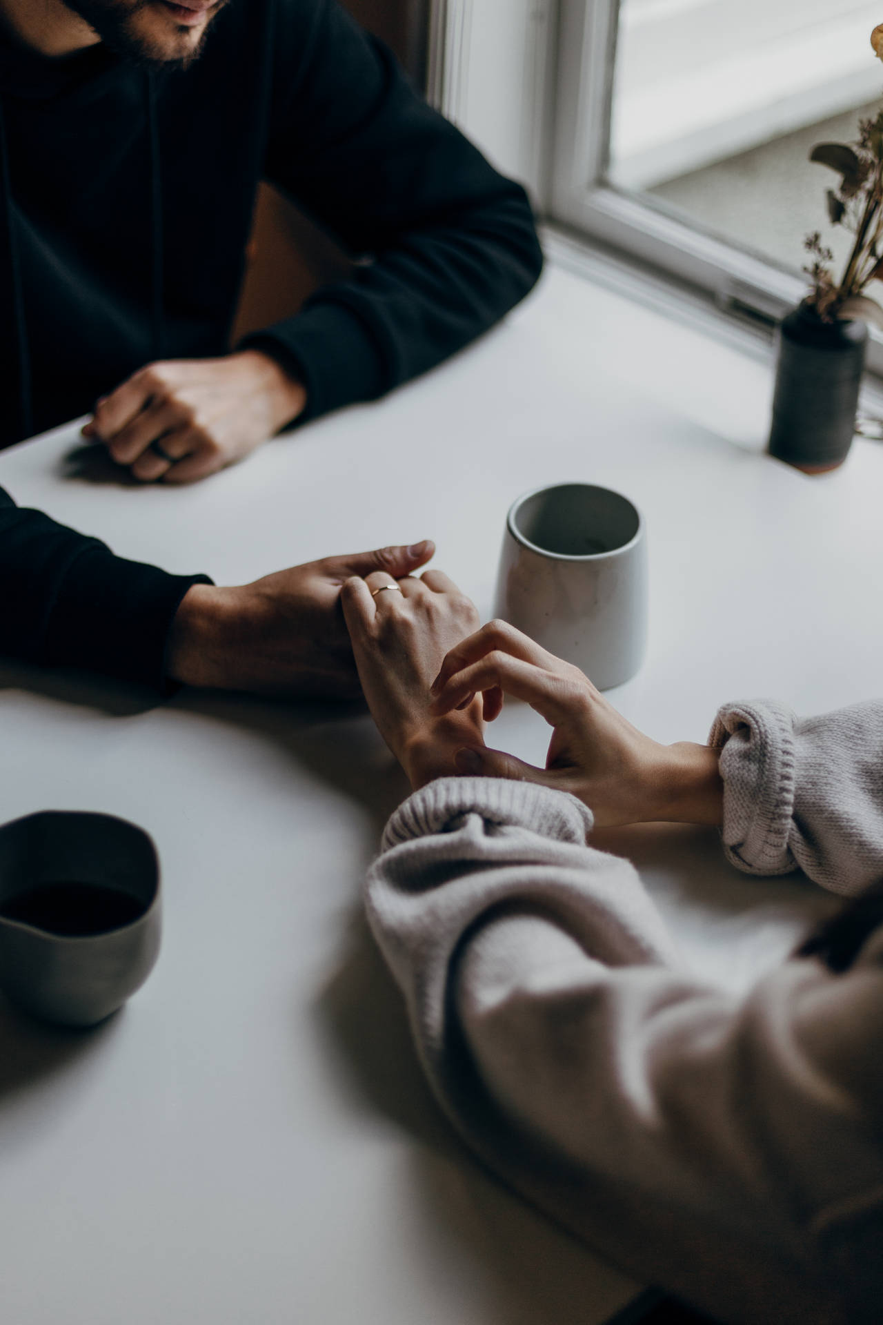 Couple Holding Hands On Table