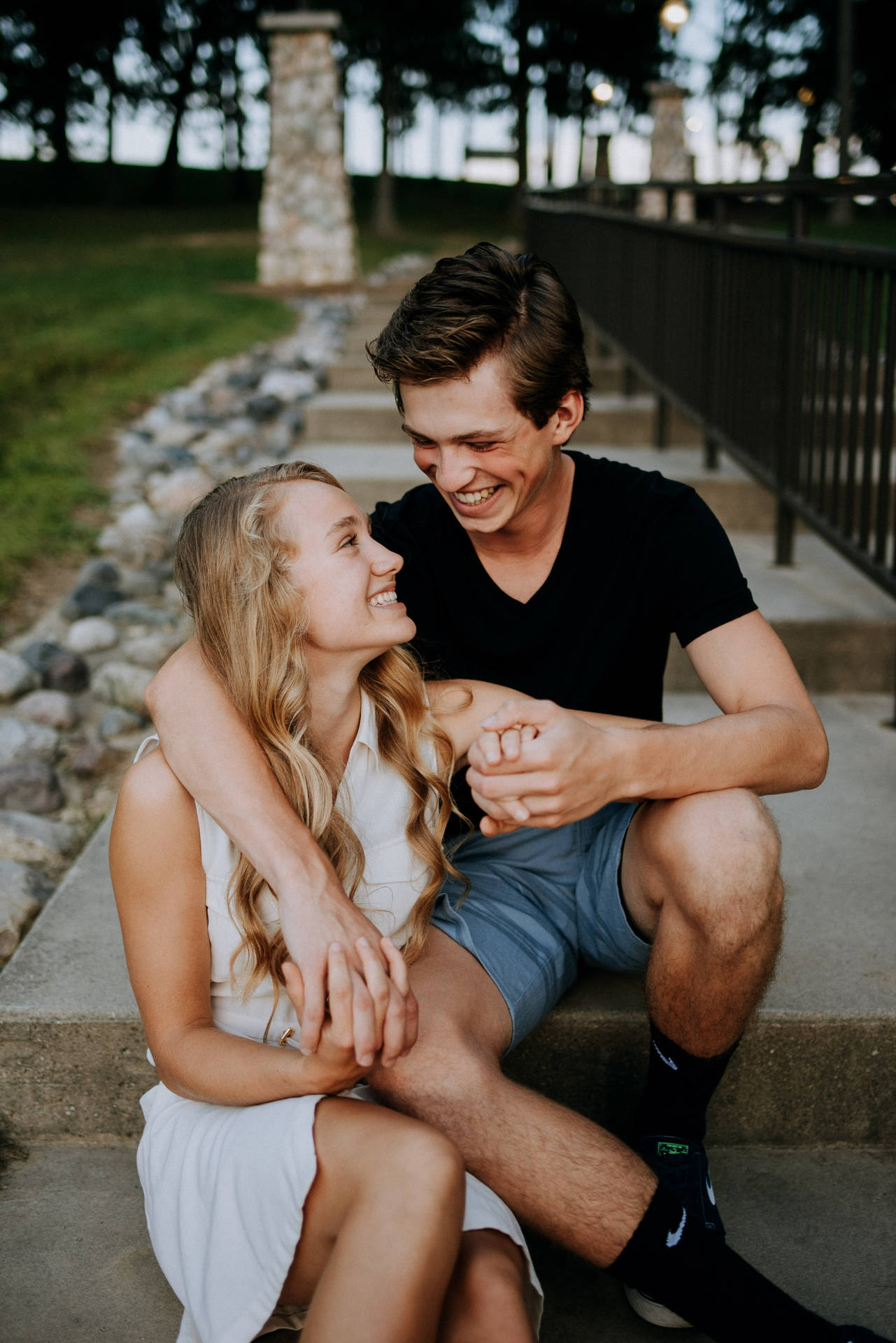 Couple Hugging And Smiling While Holding Hands Background