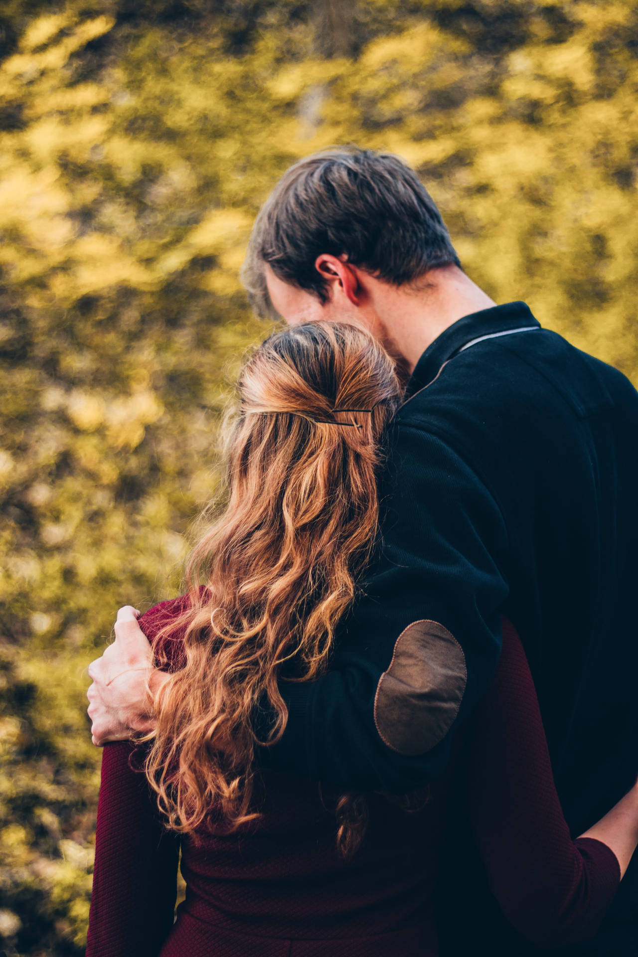 Couple Hugging In Bokeh Backdrop Background