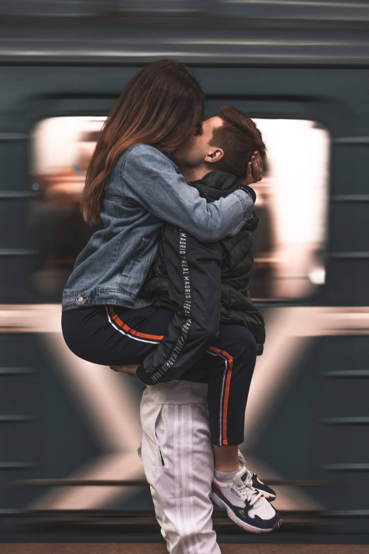 Couple Hugging In Straddle Hug Position With Motion Blur Background