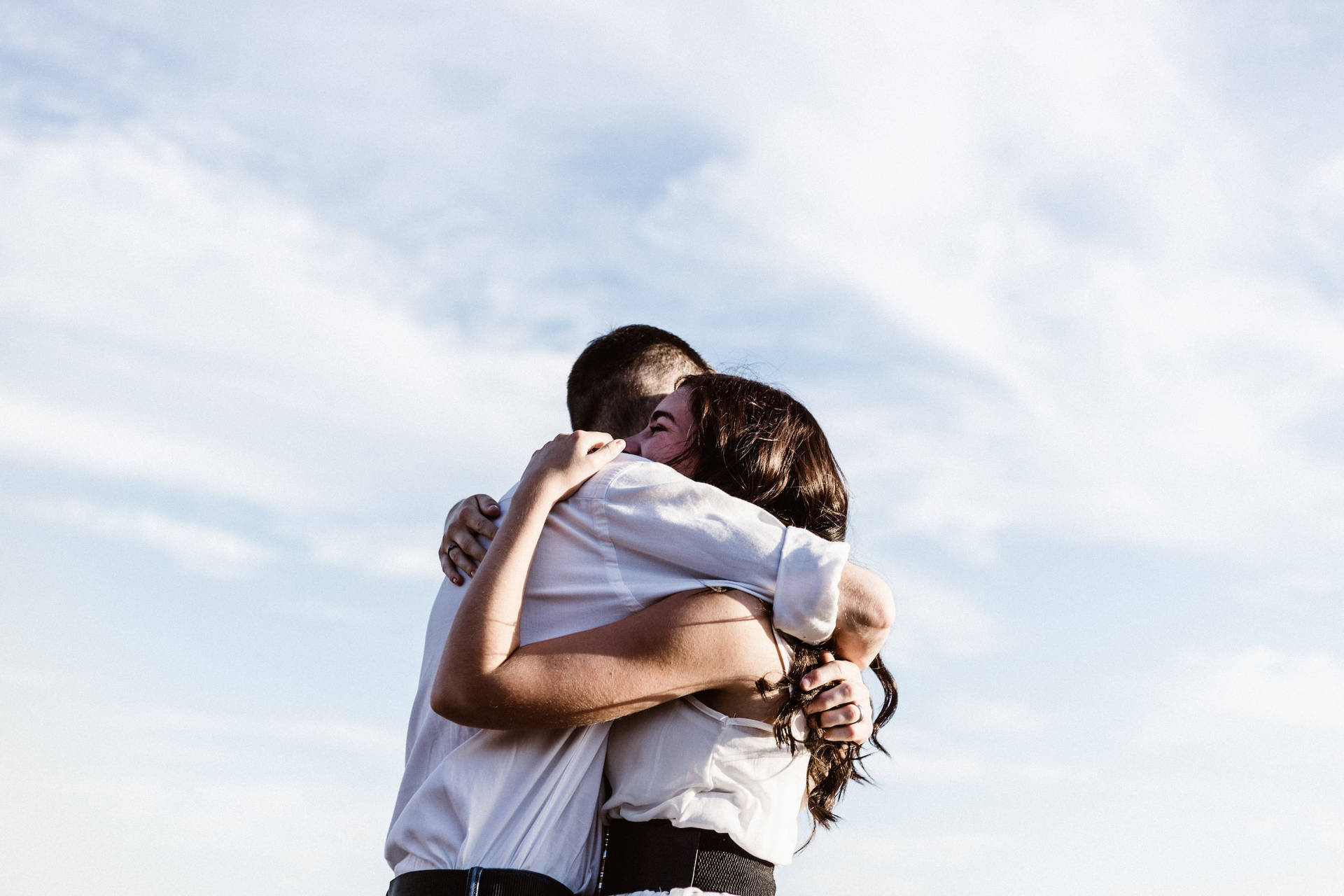 Couple Hugging Passionately On A Sunny Day Background