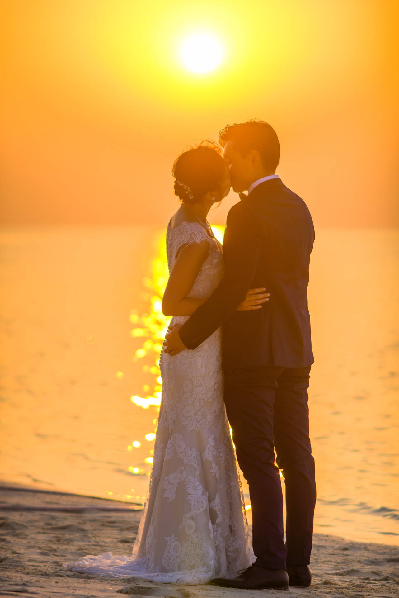 Couple In Love Kissing Under Sunset Background