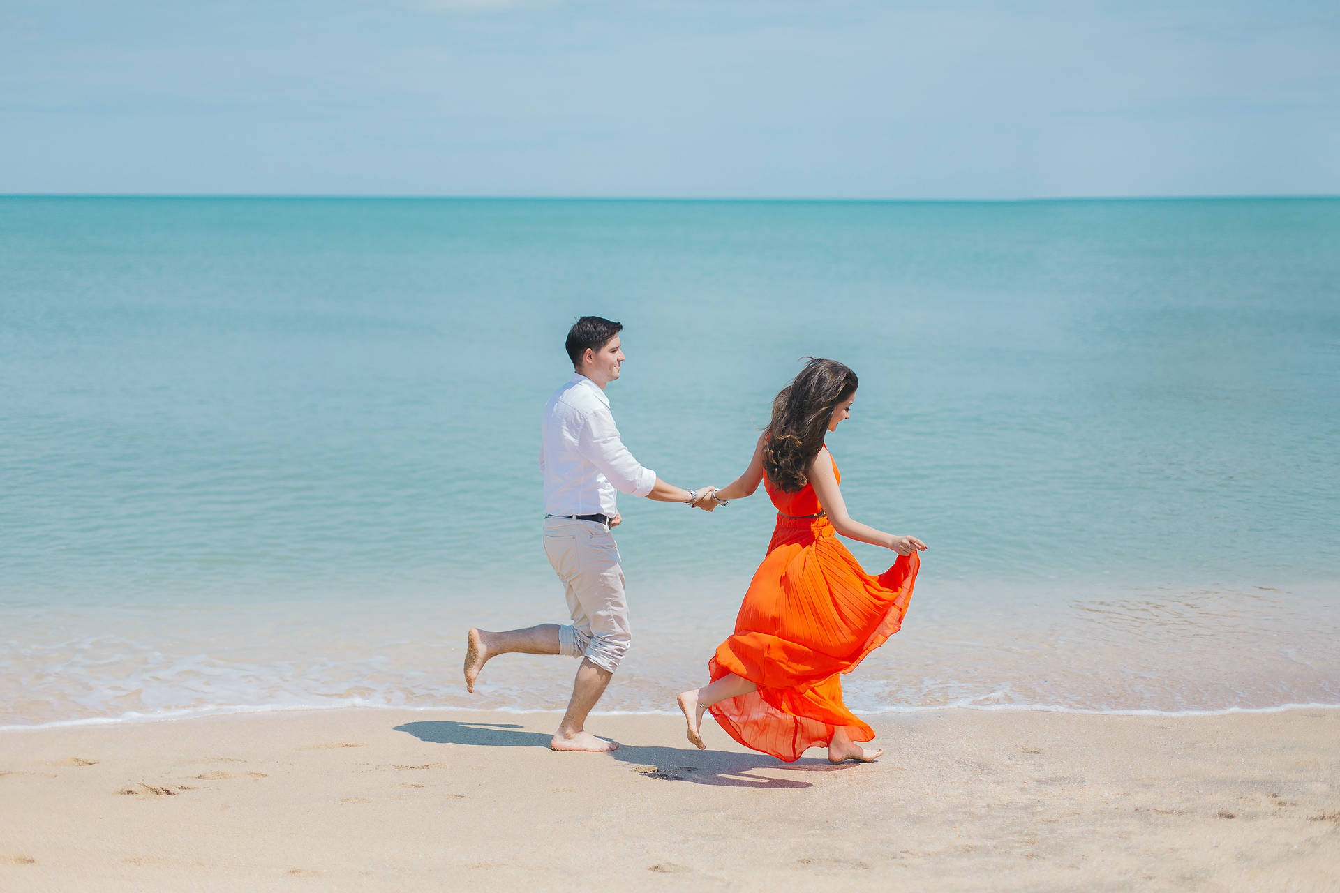 Couple In Love Walking By The Beach