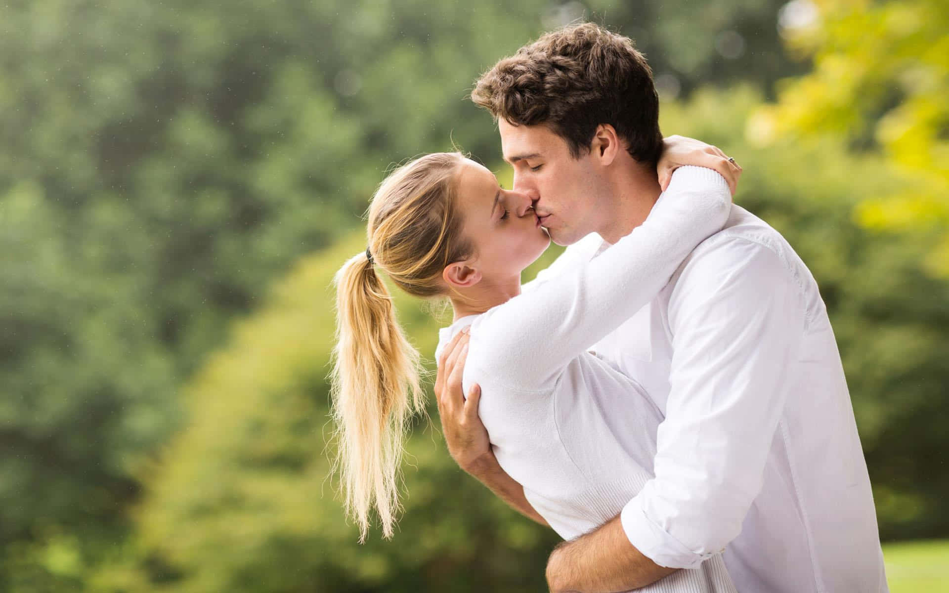 Couple In Nature Kissing Their Lips Background