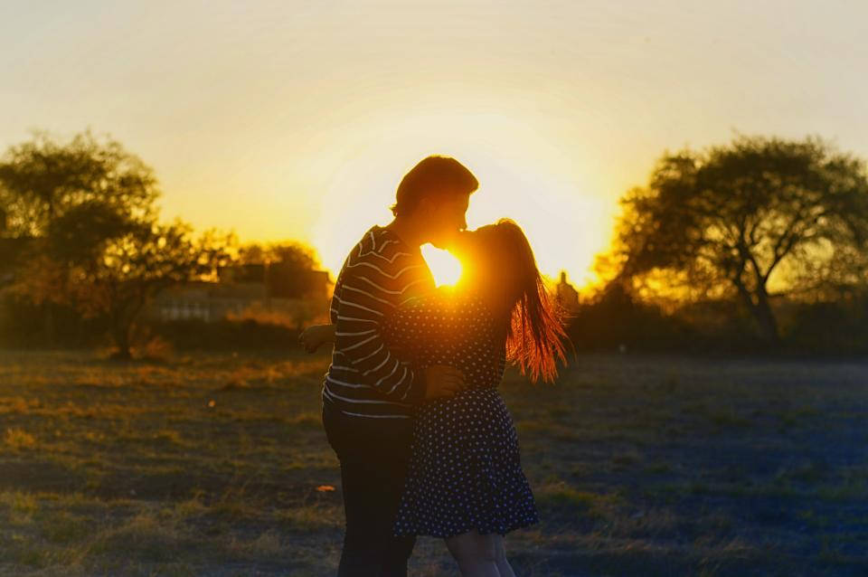 Couple Kiss On Sunrise Background