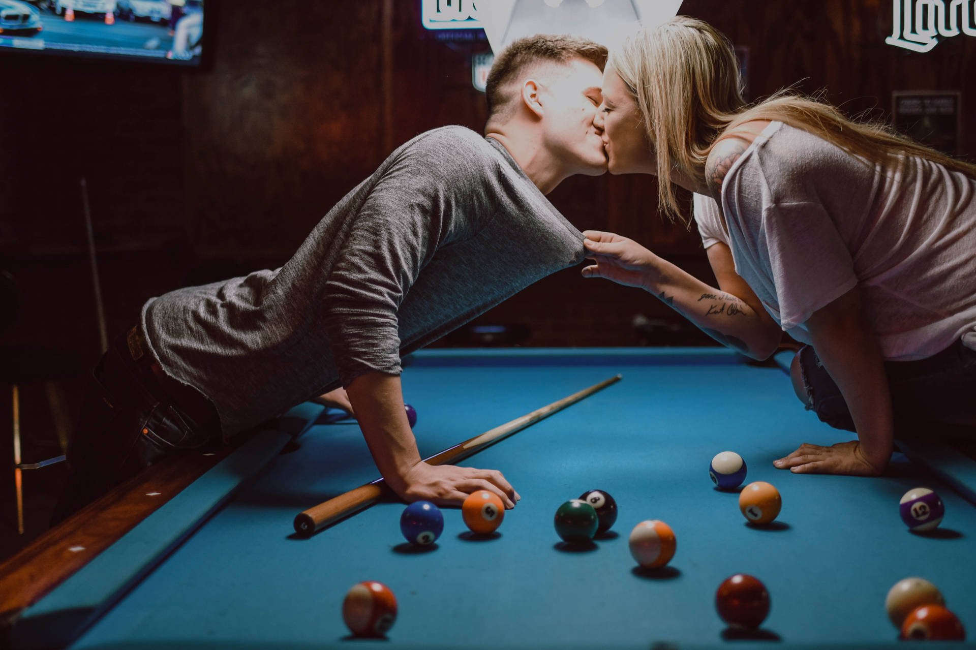 Couple Kissing On Billiard Table Background