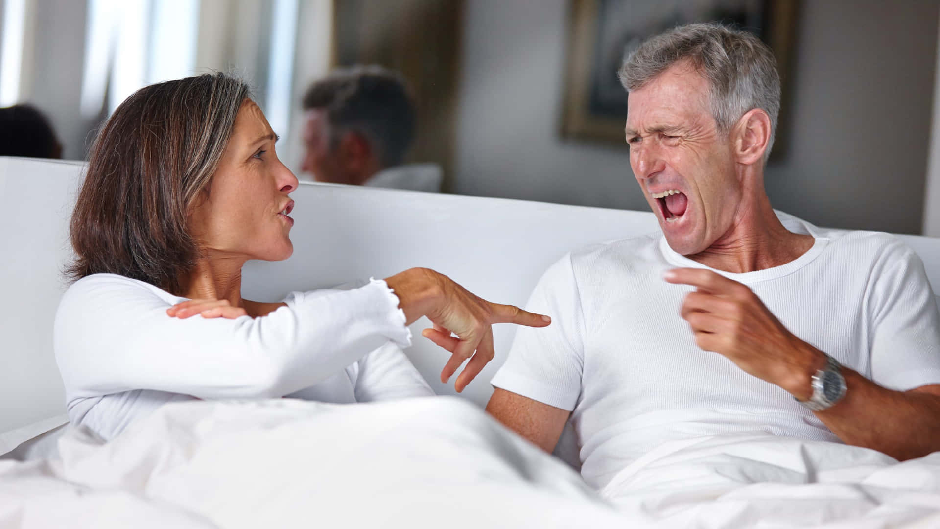 Couple Laughing Togetherin Bed Background