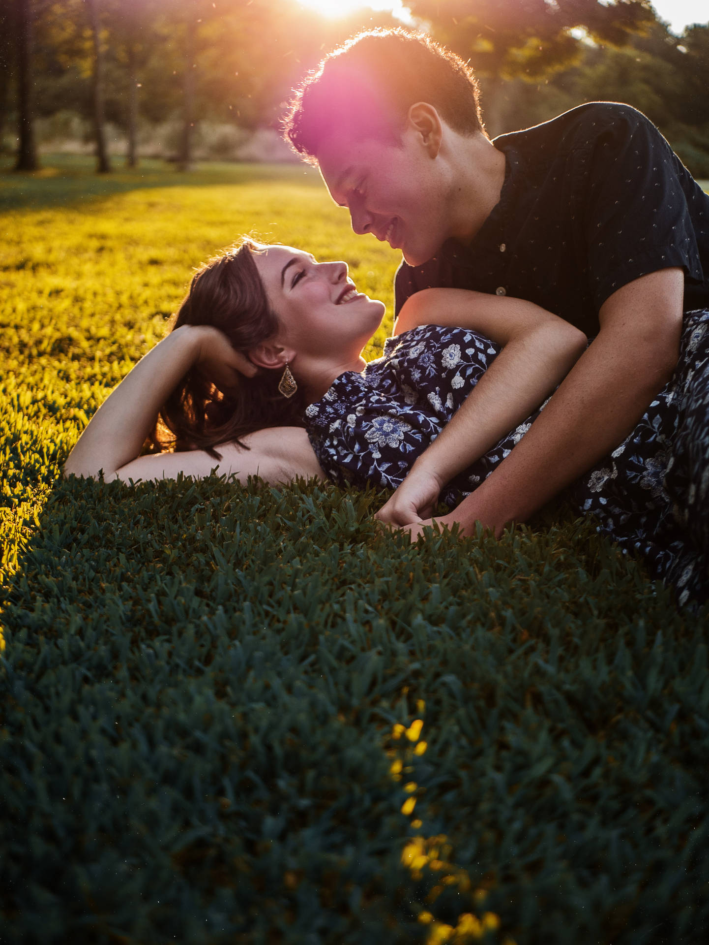 Couple Laying On Grass Background