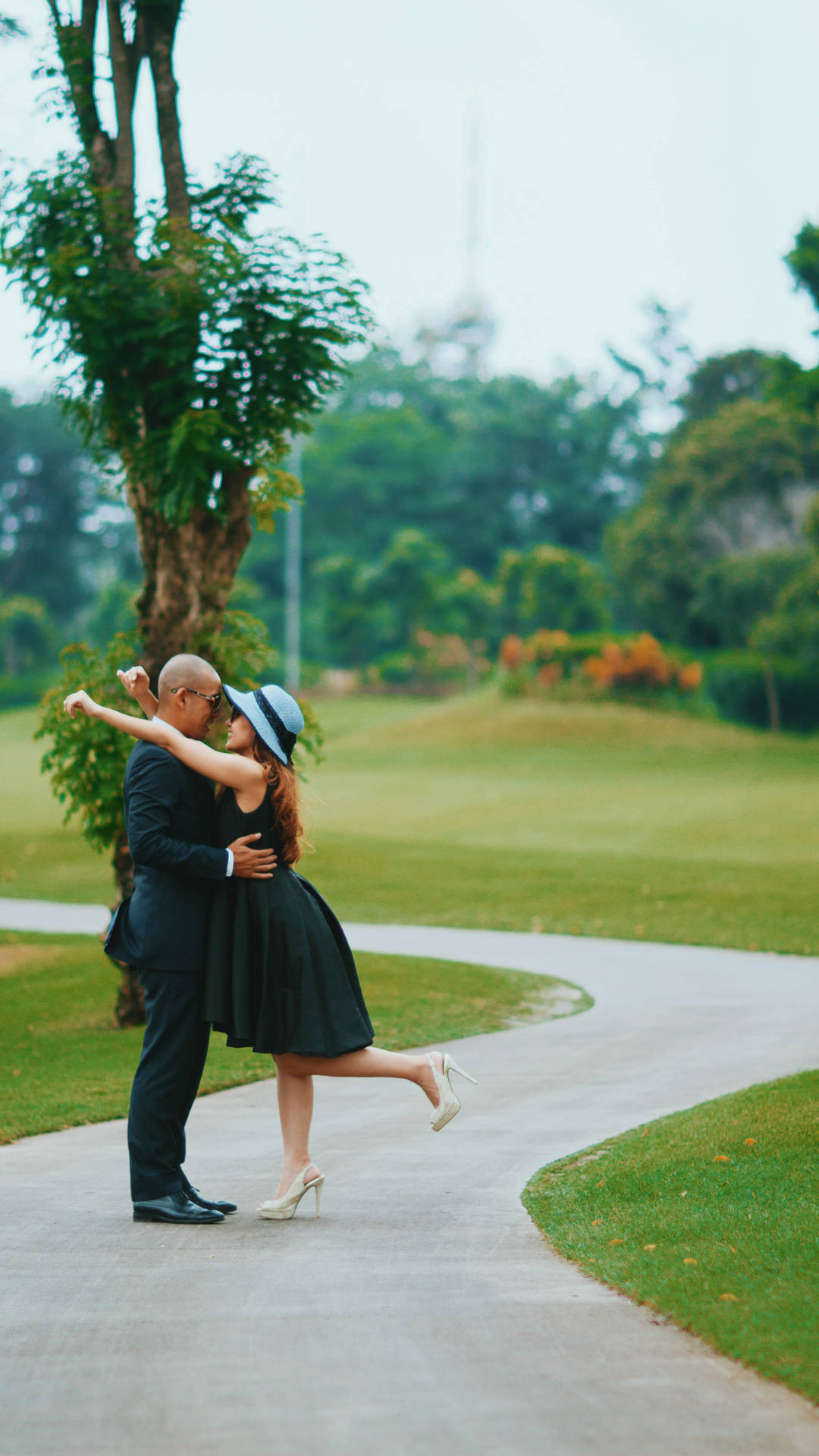 Couple On Golf Course Road Background