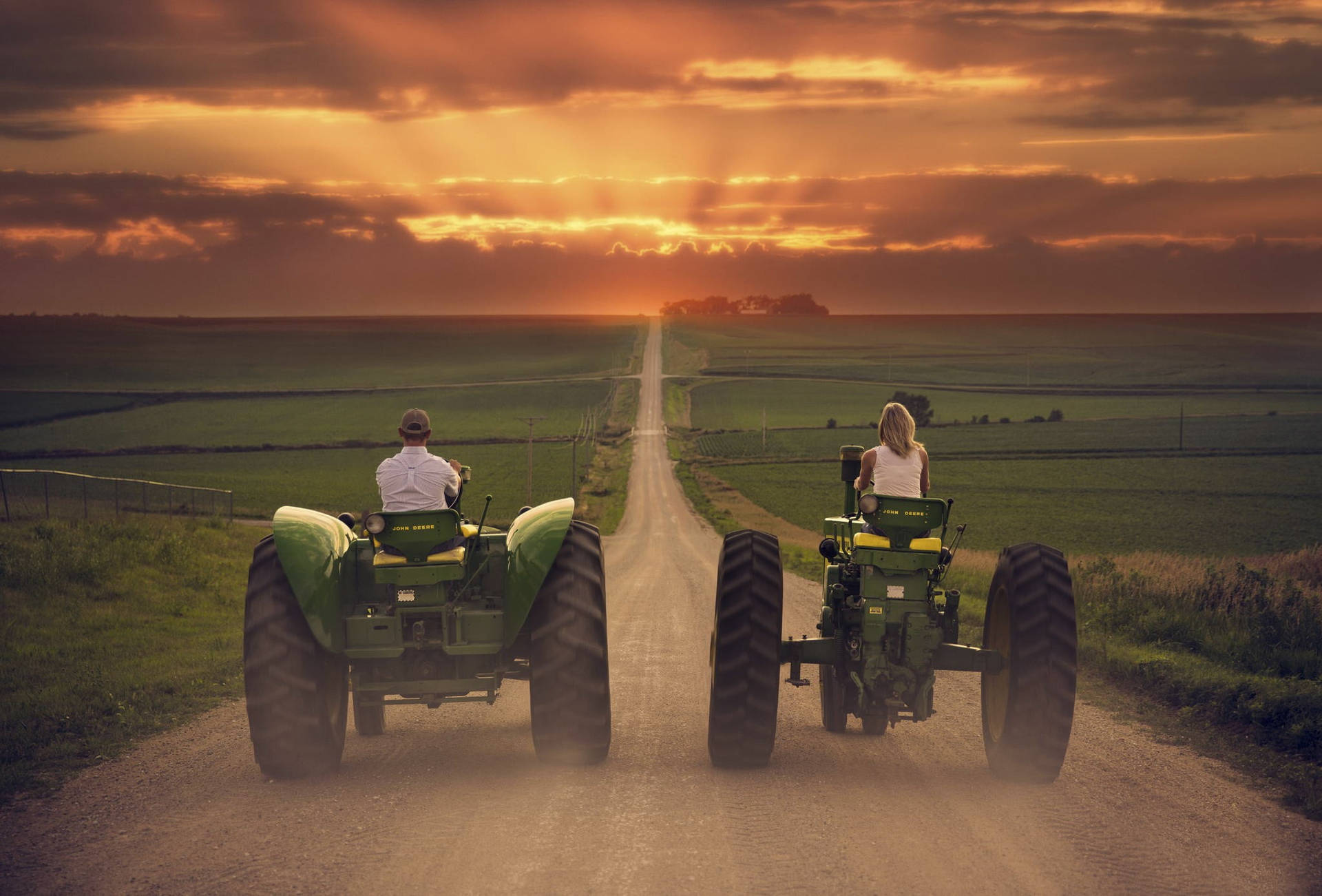 Couple Riding John Deere Tractors