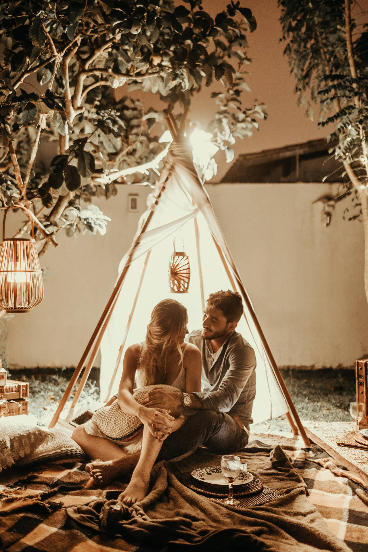 Couple Siting Inside A Tent Background