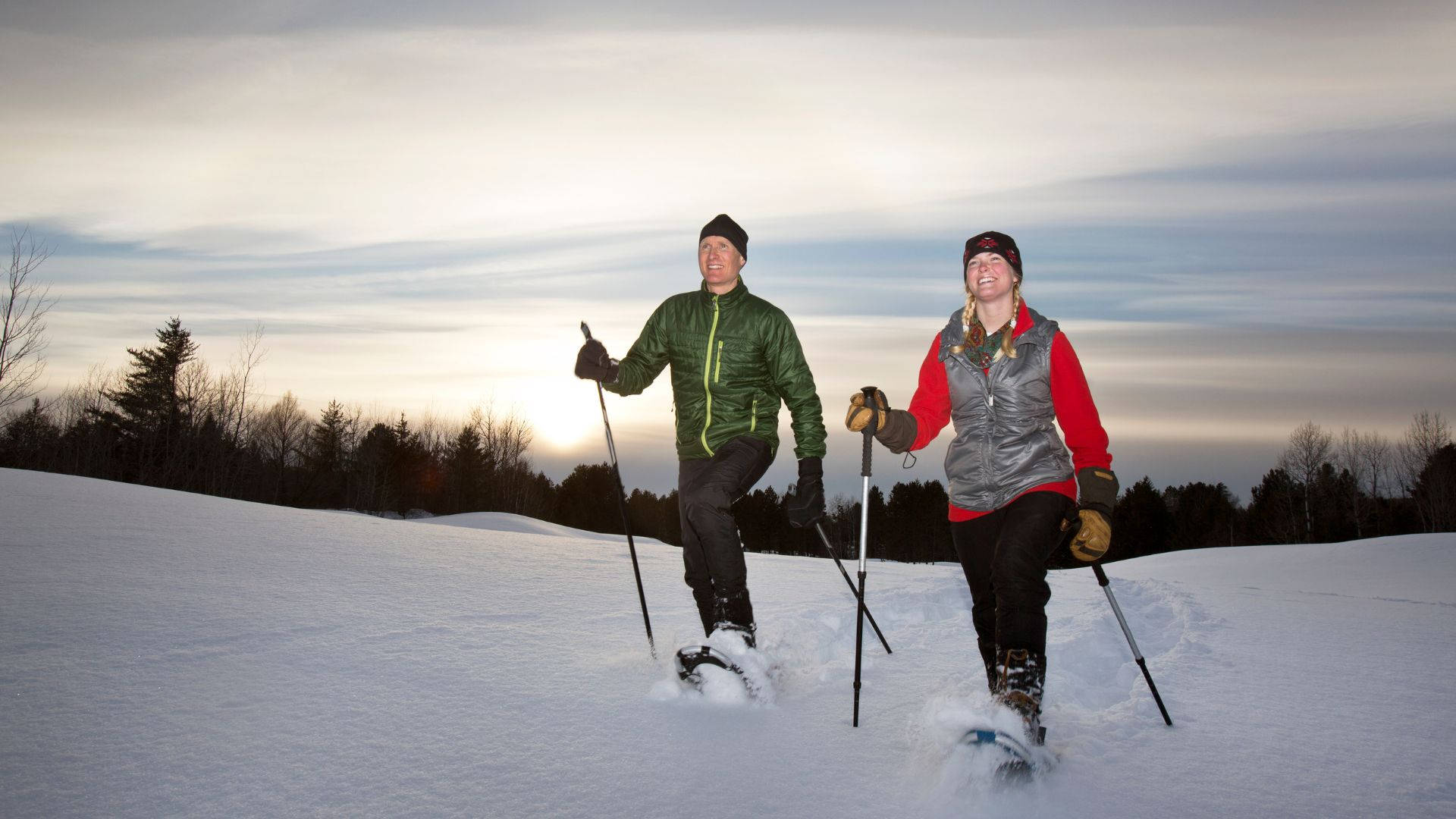 Couple Snowshoeing Walking Sunset Background