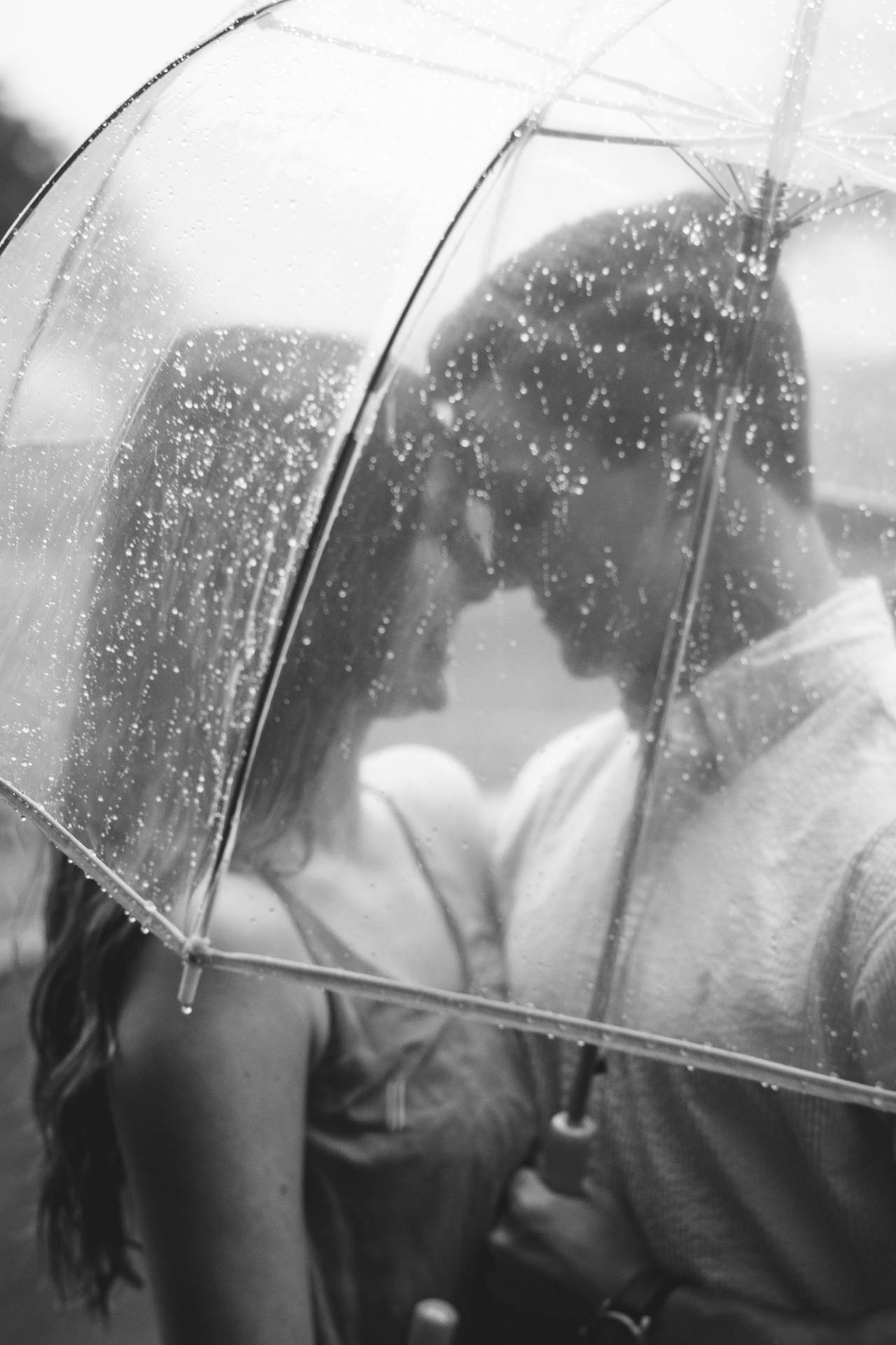 Couple Underneath The Beautiful Rain Background