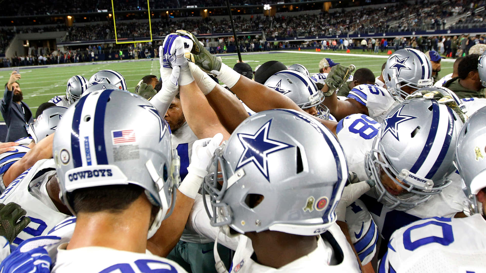 Cowboys Players Showing Their Team Spirit Background