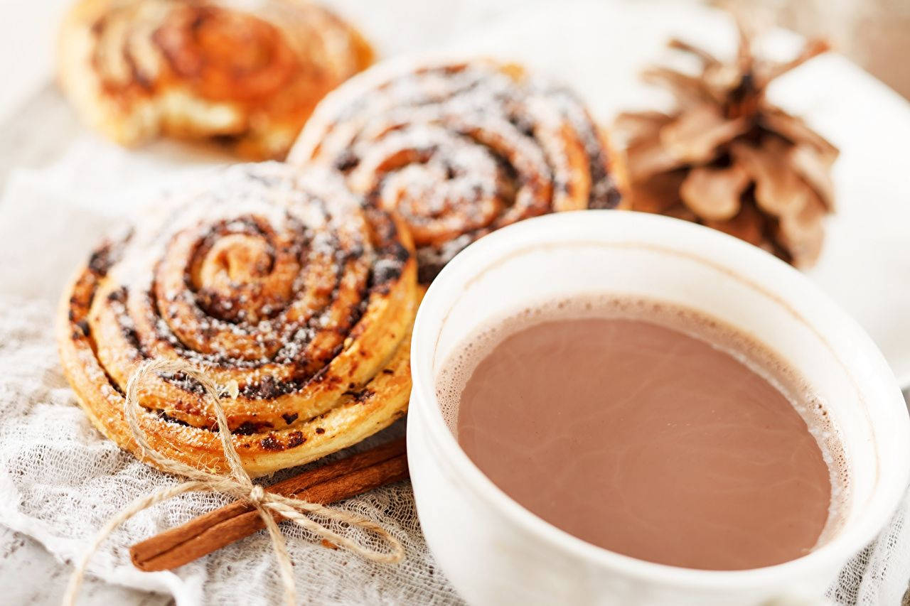 Cozy Ambience With Cinnamon Rolls And Hot Chocolate Background