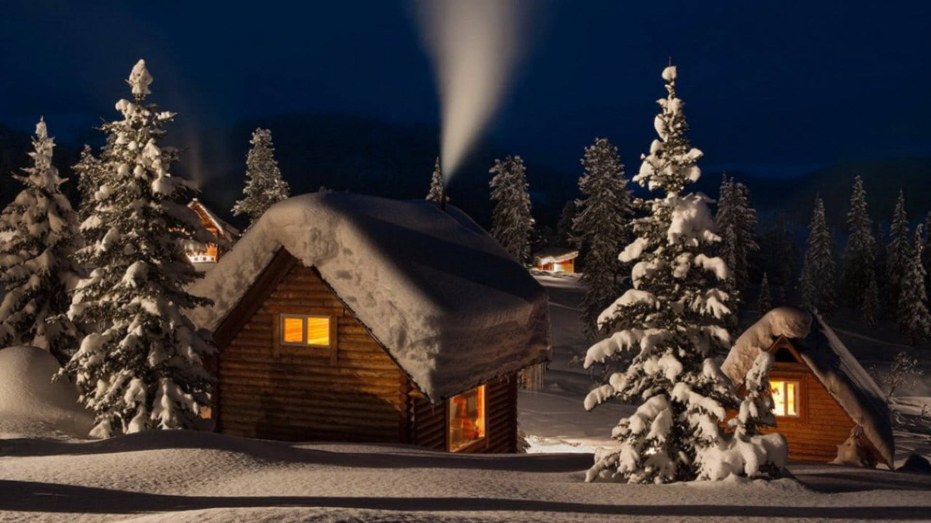 Cozy Winter Cabins On A Snowy Evening