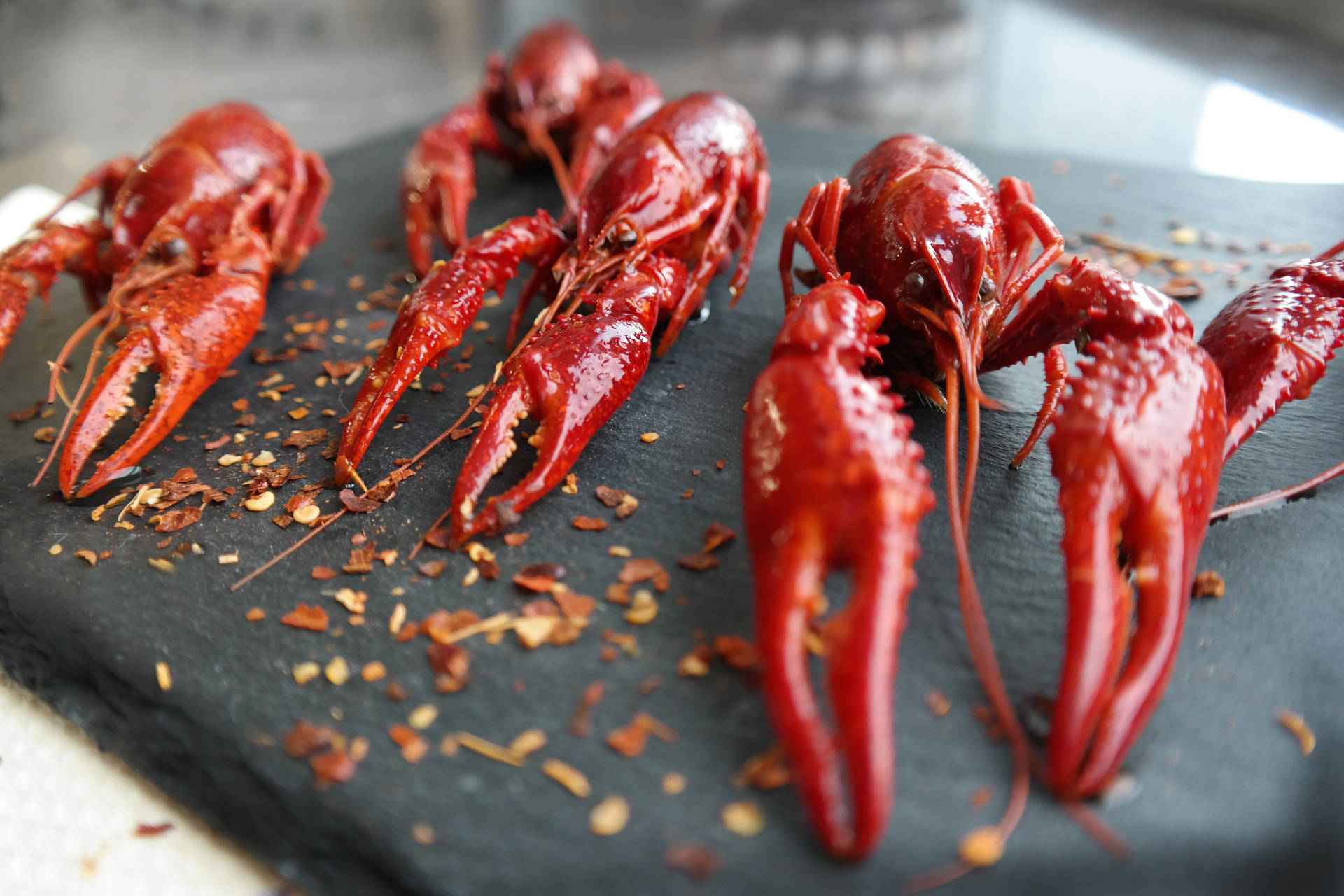 Crayfishes In Black Rock Chopping Board Background