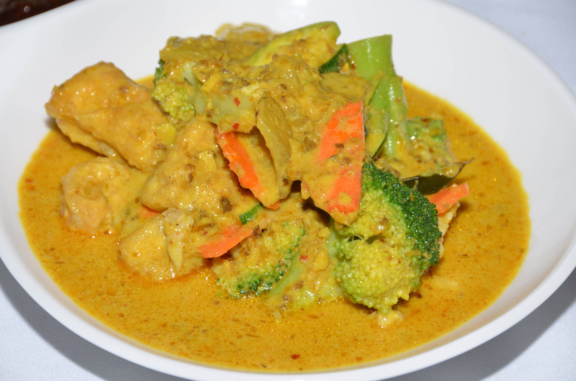 Creamy And Tasty Yellow Curry Dish In Bowl Background