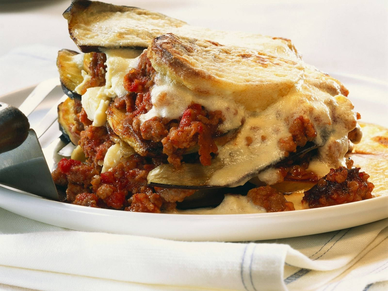 Creamy Layered Moussaka On A Plate Background