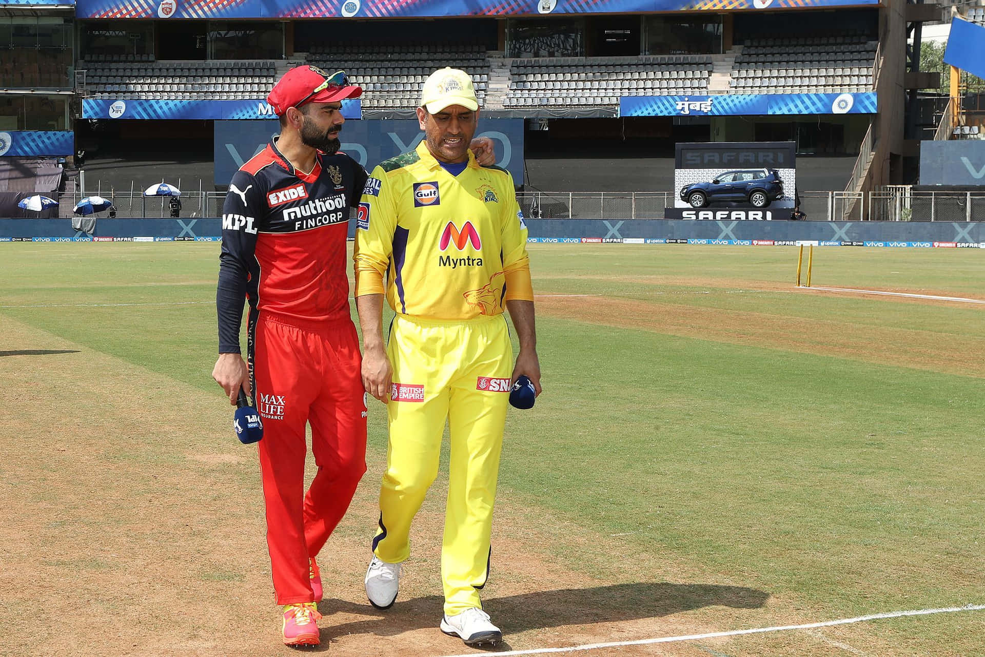 Cricket Captains Kohli Dhoni Walking On Field Background